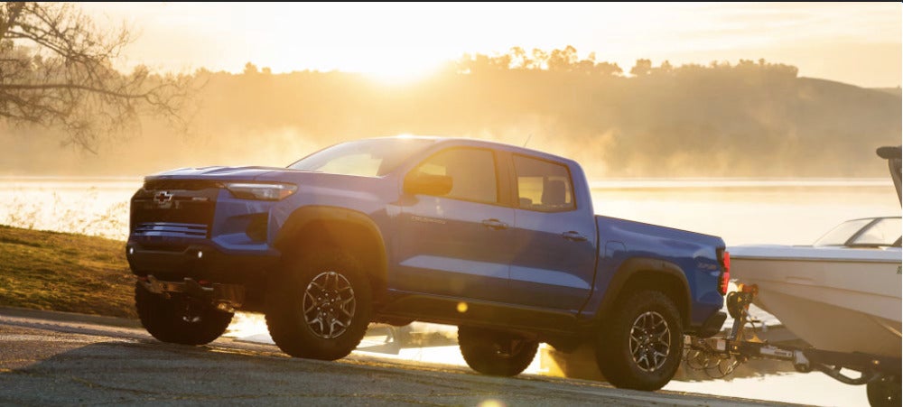 Blue Chevy Colorado towing boat